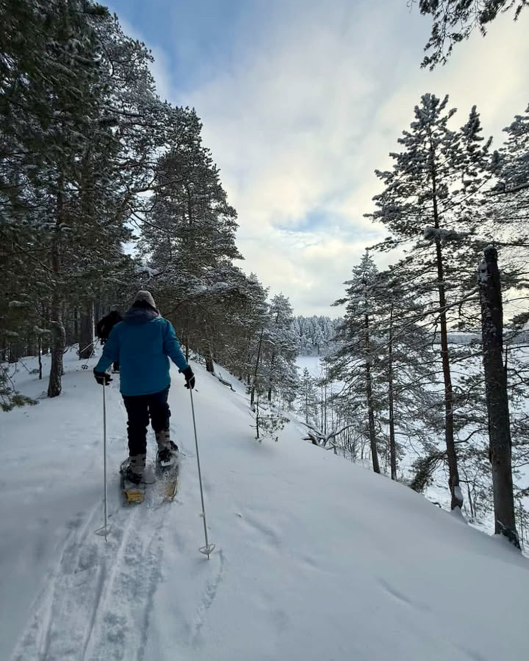 Snowshoe walk in snowy forest in Finland